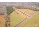 Aerial view of the property showcasing the newly constructed road that leads into a wooded area at 1502 Baileys Run, Gastonia, NC 28056