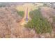 Scenic aerial shot of the new road amid a natural setting, with grassy areas and dense woods at 1502 Baileys Run, Gastonia, NC 28056