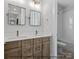 Bathroom featuring double sinks, wood cabinetry, and tile flooring at 1502 Baileys Run, Gastonia, NC 28056