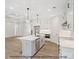 Bright kitchen with white cabinets, stainless steel appliances, and a large island at 1502 Baileys Run, Gastonia, NC 28056