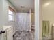 Bathroom with shower/tub combo, gray flooring, and patterned curtain at 200 Little Big Horn Dr, Dallas, NC 28034