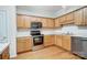 Stainless steel appliances and wood cabinets in kitchen at 2049 Stoney Point Cir, Monroe, NC 28112