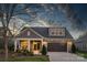 Gray craftsman style home with stone accents, two car garage, and inviting front porch at 2205 Lincolnshire Ln, Waxhaw, NC 28173