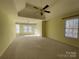 Large bedroom with high ceiling, carpet, and multiple windows at 2306 Cota Ct, Charlotte, NC 28262