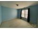 Spacious bedroom with light blue walls and carpeted floor at 2306 Cota Ct, Charlotte, NC 28262