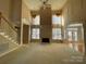 Bright living room with high ceilings, fireplace, and hardwood floors at 2306 Cota Ct, Charlotte, NC 28262