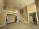 Two-story living room with fireplace and balcony at 2306 Cota Ct, Charlotte, NC 28262
