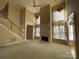 Spacious living room with high ceilings, fireplace, and hardwood floors at 2306 Cota Ct, Charlotte, NC 28262