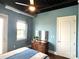 A bedroom with a light blue wall, modern furniture, and natural lighting at 2338 Yadkin Ave # 505, Charlotte, NC 28205