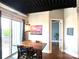 Modern dining room with a wood table, unique lighting, and access to a balcony at 2338 Yadkin Ave # 505, Charlotte, NC 28205