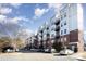 Apartment building exterior featuring brick and metal siding with multiple balconies at 2338 Yadkin Ave # 505, Charlotte, NC 28205