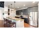 Modern kitchen featuring dark cabinets, stainless steel appliances, and a granite countertop bar with seating at 2338 Yadkin Ave # 505, Charlotte, NC 28205