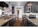 Modern kitchen featuring stainless steel appliances, granite countertops, and dark wood cabinetry at 2338 Yadkin Ave # 505, Charlotte, NC 28205