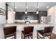 Kitchen bar with granite countertops, dark wood cabinetry, stainless appliances and seating for three at 2338 Yadkin Ave # 505, Charlotte, NC 28205