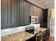 This renovated kitchen is designed with granite countertops, stainless steel appliances and dark cabinetry at 2338 Yadkin Ave # 505, Charlotte, NC 28205
