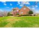 Stately brick home with manicured lawn, mature landscaping, and inviting front entrance at 2510 Burton Estates Ln, Lincolnton, NC 28092
