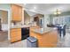 Cozy kitchen with light wood cabinets, stainless steel appliances, granite countertops, and adjacent dining area at 3613 Savannah Way, Monroe, NC 28110