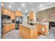 Well-lit kitchen with light wood cabinets, stainless steel appliances, granite countertops, and open layout at 3613 Savannah Way, Monroe, NC 28110