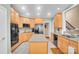 Bright kitchen with light wood cabinets, stainless steel appliances, granite countertops, and a functional center island at 3613 Savannah Way, Monroe, NC 28110