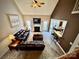 Overhead shot of a living room featuring vaulted ceiling, fireplace and open layout to the dining area at 3613 Savannah Way, Monroe, NC 28110