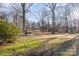 Large backyard with a fire pit and wooded area at 605 Impala Dr, Albemarle, NC 28001