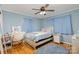 Bedroom with light blue walls, ceiling fan and wood flooring at 605 Impala Dr, Albemarle, NC 28001