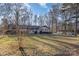 Brick ranch house with dark trim and a large yard, side view at 605 Impala Dr, Albemarle, NC 28001
