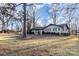 Brick ranch house with dark trim and a large yard, side view at 605 Impala Dr, Albemarle, NC 28001