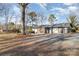 Ranch house with a gravel driveway and large backyard at 605 Impala Dr, Albemarle, NC 28001