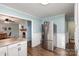Kitchen boasts stainless steel refrigerator and view into living room at 605 Impala Dr, Albemarle, NC 28001
