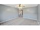 Large bedroom with ceiling fan and carpet at 6345 Cora St, Charlotte, NC 28216