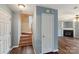 Staircase and hallway leading to living area with fireplace at 6345 Cora St, Charlotte, NC 28216