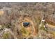 Aerial view of house nestled in wooded area with a stream nearby at 663 Chadbourne Nw Ave, Concord, NC 28027