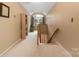 Upper hall with built-in shelving and view of staircase at 7857 Nine Iron Ct, Denver, NC 28037