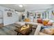 Open living room with L-shaped sofa and view into dining area at 905 Littleton Dr, Concord, NC 28025