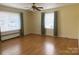 Bedroom featuring hardwood floors, neutral walls, ceiling fan, and natural light from the windows at 936 N 5Th St, Albemarle, NC 28001