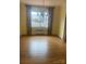Living room featuring hardwood floors, neutral walls, chandelier and natural light from the large window at 936 N 5Th St, Albemarle, NC 28001