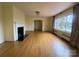 Spacious living room featuring hardwood floors, neutral walls, a fireplace, chandelier and natural light at 936 N 5Th St, Albemarle, NC 28001
