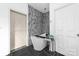 Spa-like bathroom with a freestanding soaking tub and a modern barn door at 1009 Murandy Ln, Matthews, NC 28104