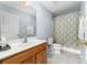 Simple bathroom with shower/tub combo and wood vanity at 1009 Murandy Ln, Matthews, NC 28104