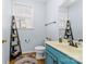 Clean bathroom with teal vanity, white toilet, and decorative shelving at 1009 Murandy Ln, Matthews, NC 28104