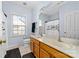 Clean bathroom with double sinks, a shower/tub combo, and a large mirror at 1009 Murandy Ln, Matthews, NC 28104