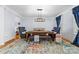 Elegant dining room showcasing hardwood floors, a statement rug, and stylish navy chairs at 1009 Murandy Ln, Matthews, NC 28104