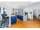 Modern kitchen boasting a large island with blue cabinetry and quartz countertops at 1009 Murandy Ln, Matthews, NC 28104