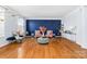 Bright living room with hardwood floors, stylish furniture, and a dramatic blue accent wall at 1009 Murandy Ln, Matthews, NC 28104