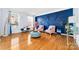 Spacious living room featuring hardwood floors, blue accent wall, and chic seating at 1009 Murandy Ln, Matthews, NC 28104