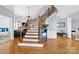 Elegant staircase with ornate railing and hardwood floors at 1009 Murandy Ln, Matthews, NC 28104