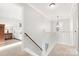 Upstairs hallway with chandelier and access to bedrooms at 1138 Millwright Ln, Matthews, NC 28104