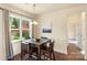 Bright breakfast nook with a square table and four chairs, overlooking the backyard at 11414 Cedarvale Farm Pkwy, Midland, NC 28107