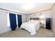 Main bedroom with a queen-size bed and navy blue curtains at 1212 Hines Rd, Clover, SC 29710